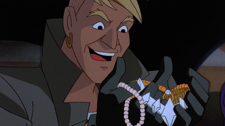 A thief admires various precious jewel necklaces
