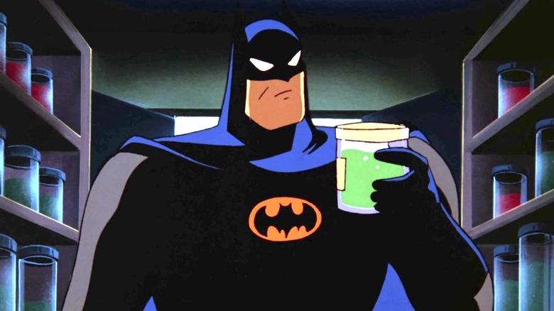 Batman inspects a jar