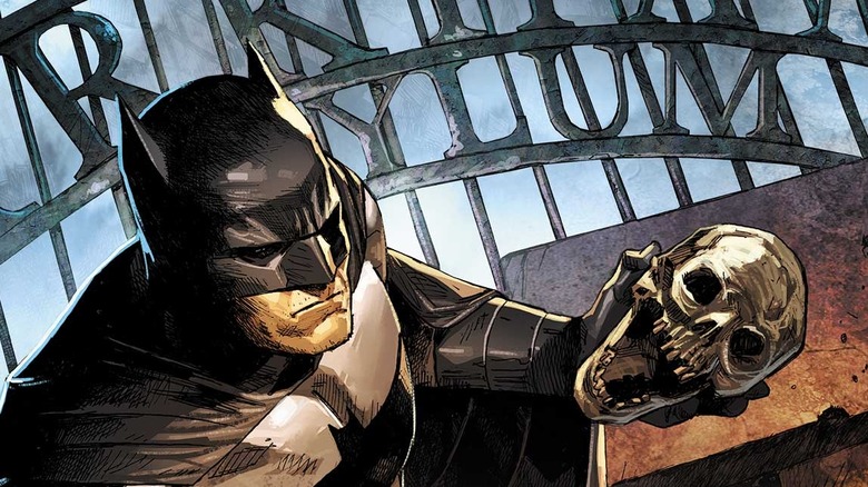 Batman holds skull