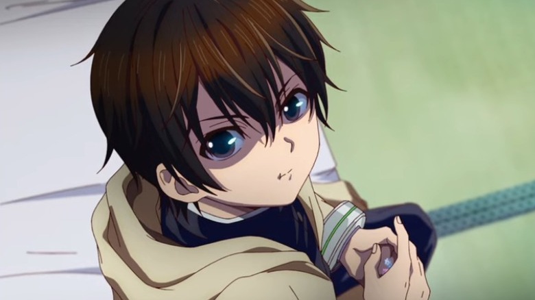 Kei looking at a camera spying on him