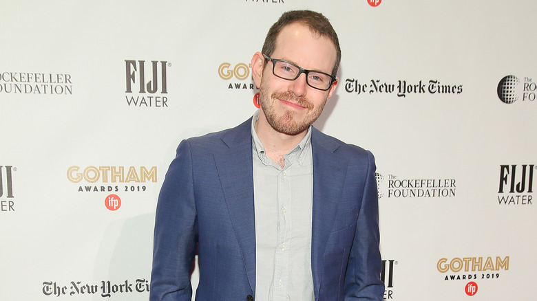 Ari Aster smiling on red carpet