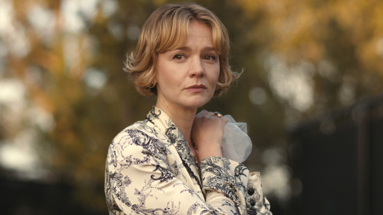 Lindsay holding an ice pack on her shoulder while frowning in 