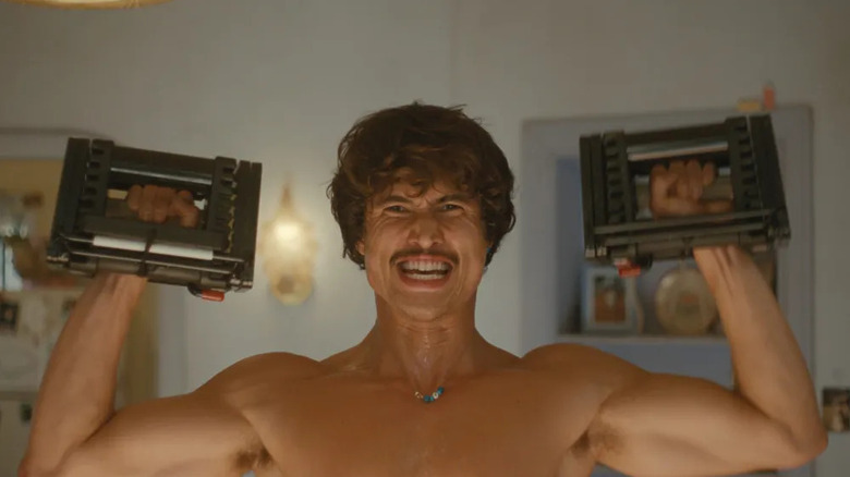 Austin grimaces while lifting blocky weights on "Beef"