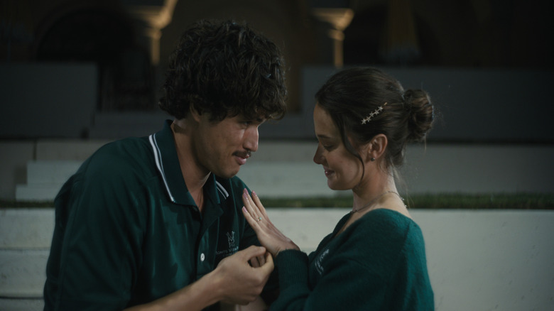 Austin and Ashley, both wearing green, touch each other in "Beef"