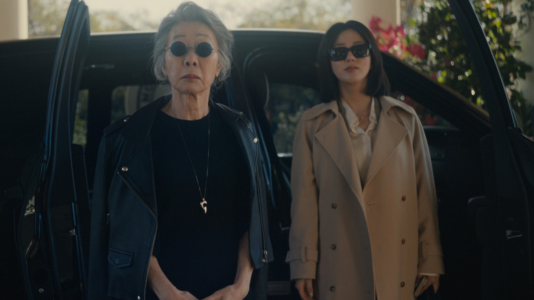 Chairwoman Park and Eunice exit a black SUV on "Beef"