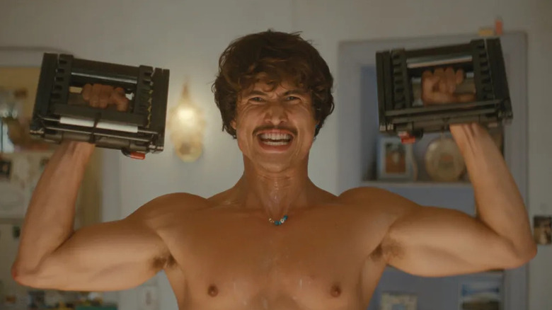 Austin grimaces while lifting blocky weights on "Beef"