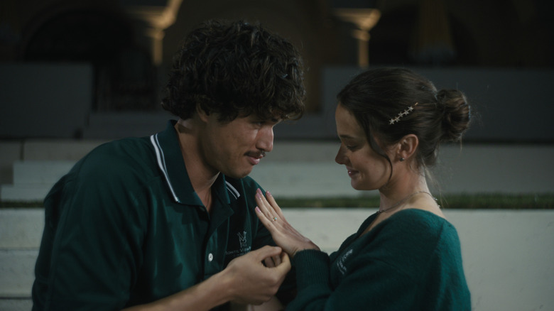 Austin and Ashley, both wearing green, touch each other in "Beef"