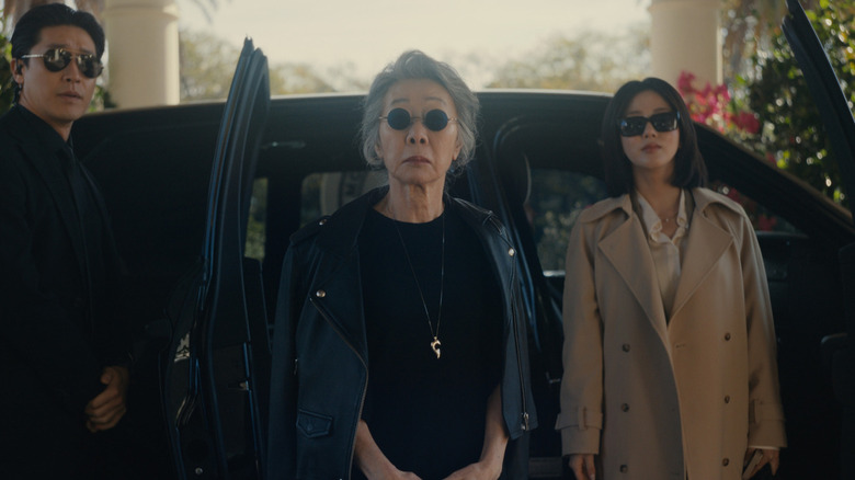 Chairwoman Park and Eunice exit a black SUV on "Beef"