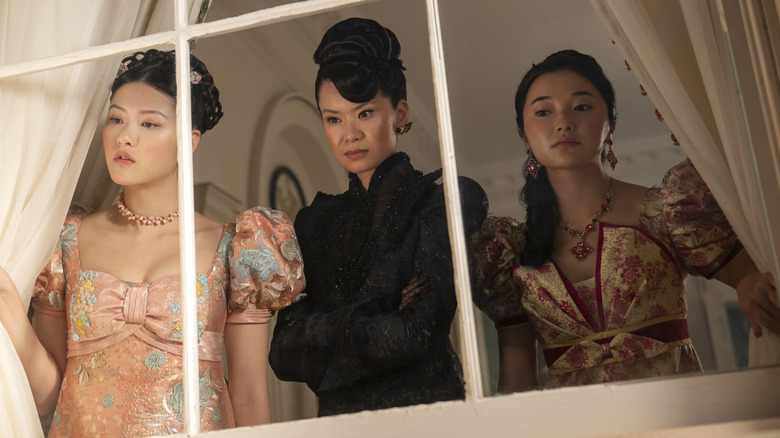 Posy, Lady Araminta Gun, and Rosamund looking out a window in "Bridgerton."