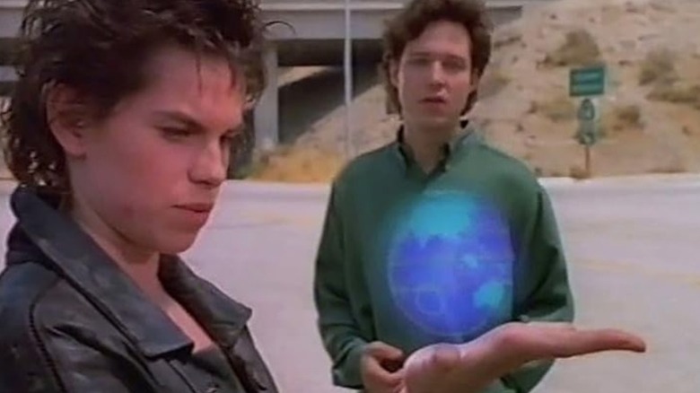 Cat holding a glowing orb while Thomas Mason watches on Doorways