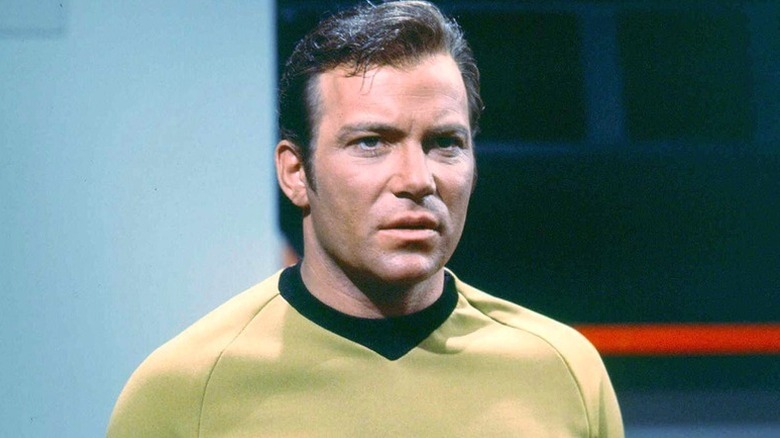Captain Kirk standing in a ship on "Star Trek"