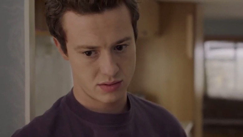 Tom looking serious in his caravan in 