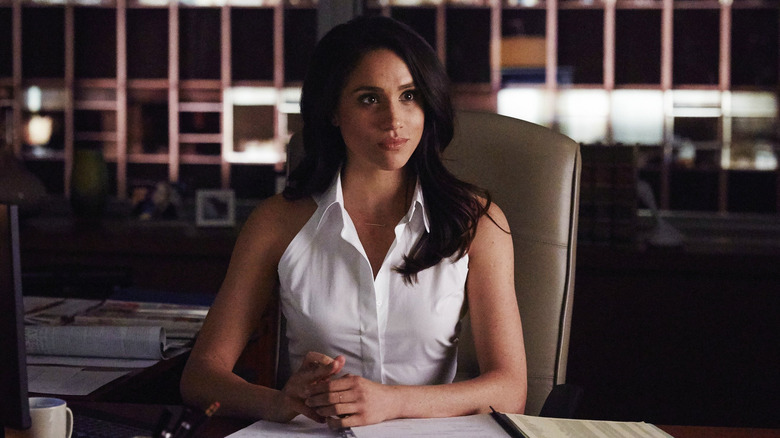 Rachel Zane sitting at her desk in Suits
