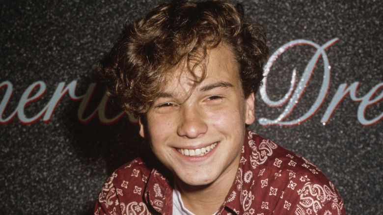 A young Johnny Galecki smiling for the camera in the early 1990s
