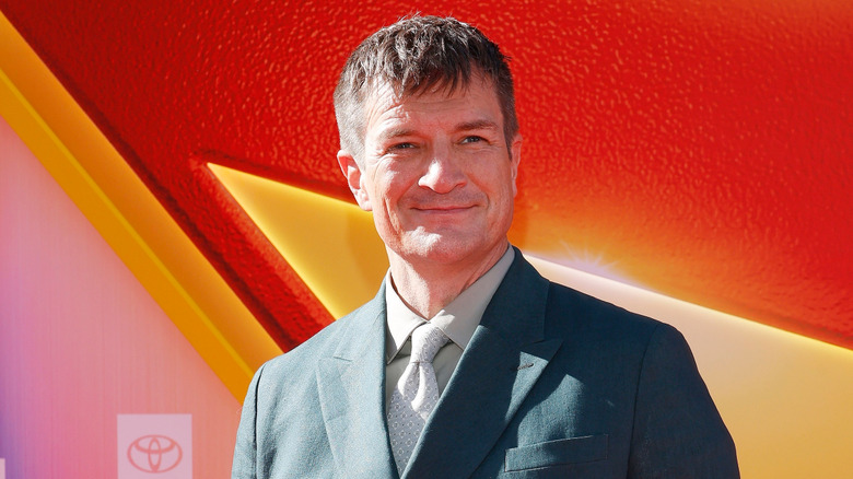 Nathan Fillion smiling at the "Superman" premiere in Hollywood in 2025.