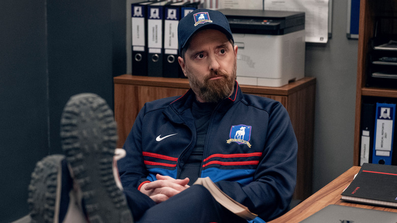 Coach Beard feet on desk