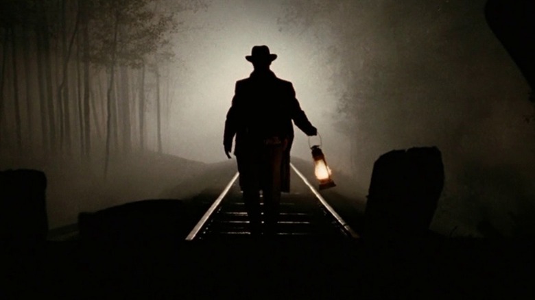 A solitary lantern illuminating darkened train tracks in "The Assassination of Jesse James by the Coward Robert Ford" (2007)