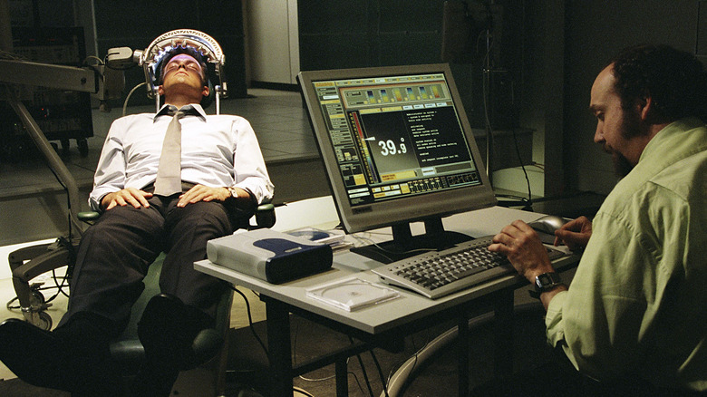 Jennings lays back in a mind-wiping device while Shorty sits at a computer in "Paycheck"