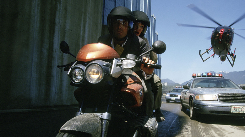 Jennings rides a motorcycle while Rachel holds onto his back in "Paycheck"
