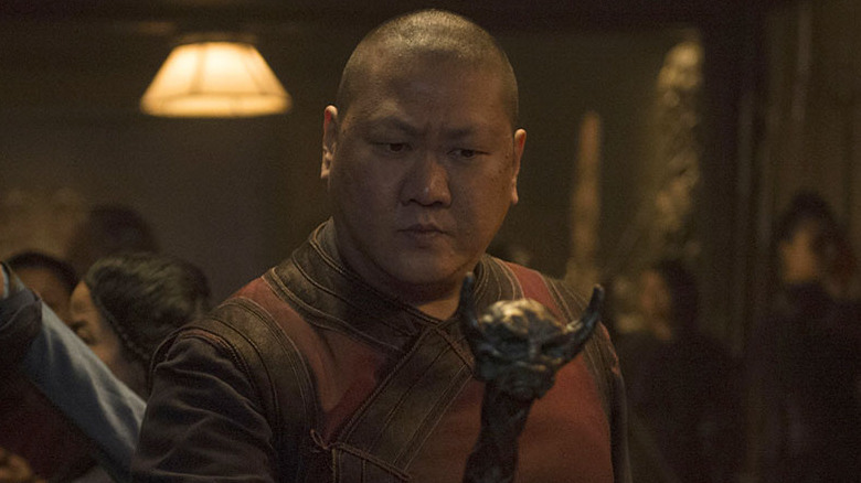 Wong holding staff