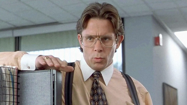 Lumbergh stands at a desk in 