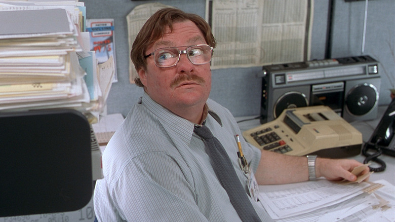 Milton tries to protect his desk in "Office Space" (1999)