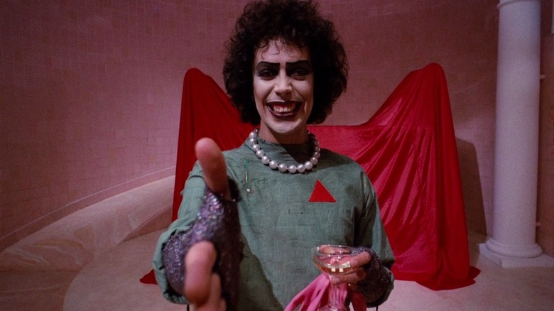 Dr. Frank-N-Furter holding out hand