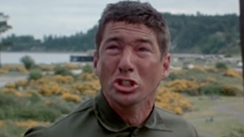 Zach Mayo grimacing outdoors