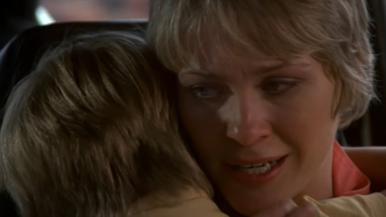 Donna holds Tad in car Cujo