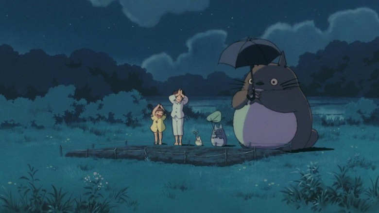 Mei and Satsuki Kusakabe and the three Totoros standing out on a field at night in My Neighbor Totoro (1988)