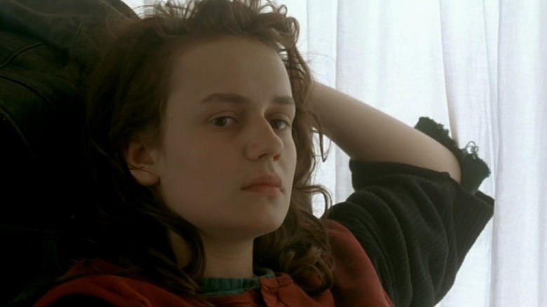 Mona Bergeron sitting with her left hand on her head in Vagabond (1985)