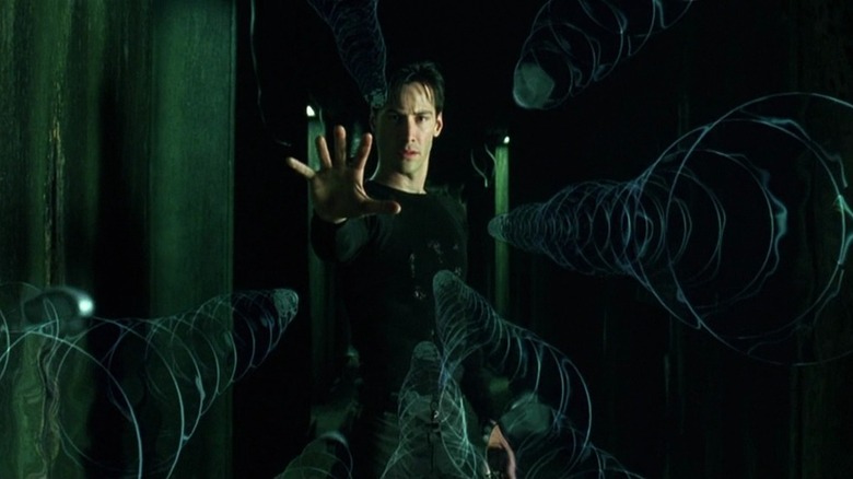 Neo (Keanu Reeves) stops bullets