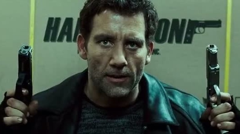 Mr. Smith holding two guns in "Shoot 'Em Up" (2007)