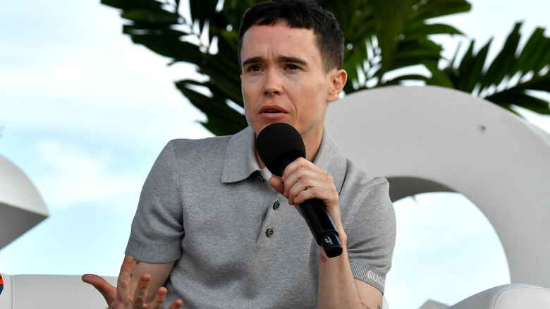 Elliot Page speaking on a microphone