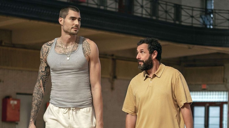 Stanley Sugarman walks with a basketball player
