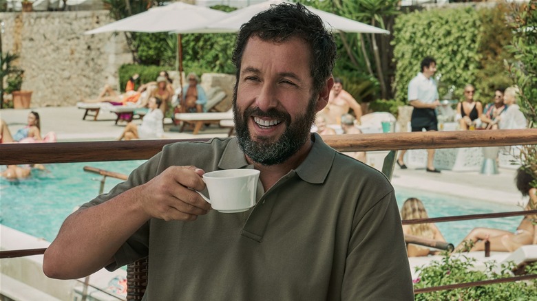 Stanley Sugerman smiling while holding mug outside