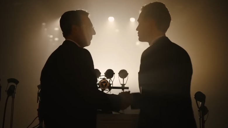 President Lindbergh shaking hands with a man as he steps up to a podium in The Plot Against America (2020)