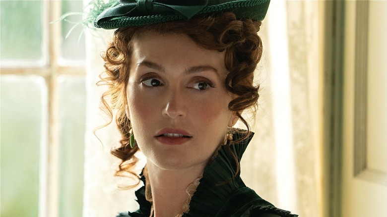 Nell wearing a fancy hat in The Buccaneers