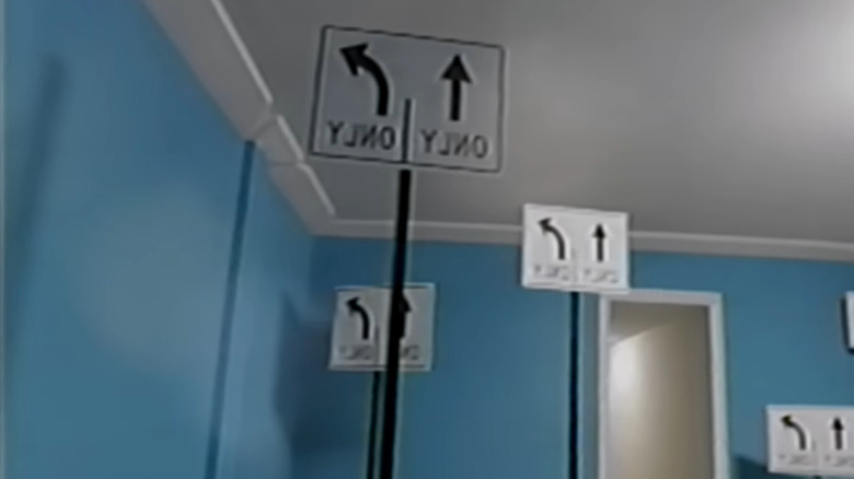 Inverted street signs inside a house in The Backrooms
