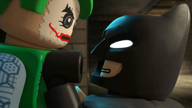 Batman holding up Joker in Lego Batman: Legacy of the Dark Knight