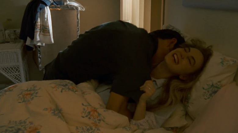 Cheryl laughing in bed in Body Melt