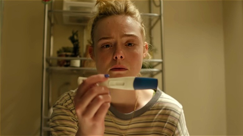 Margo checks a pregnancy test in Margo's Got Money Troubles