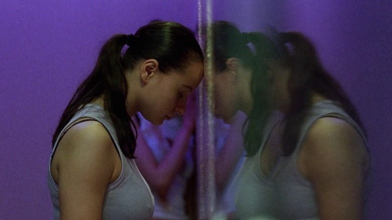 Morvern leaning her head against a mirrored wall in Morvern Callar