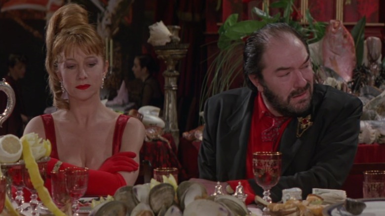 Georgina and Albert sitting side by side at a table in The Cook, the Thief, His Wife, & Her Lover