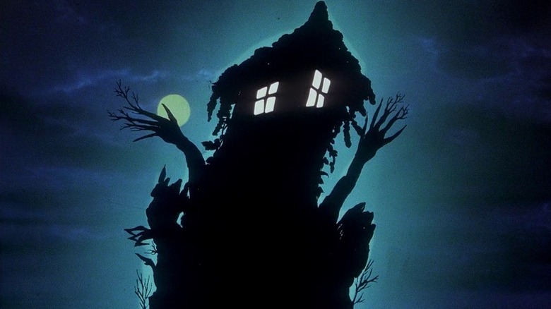 Exterior of a strange-looking house against a moonlit sky