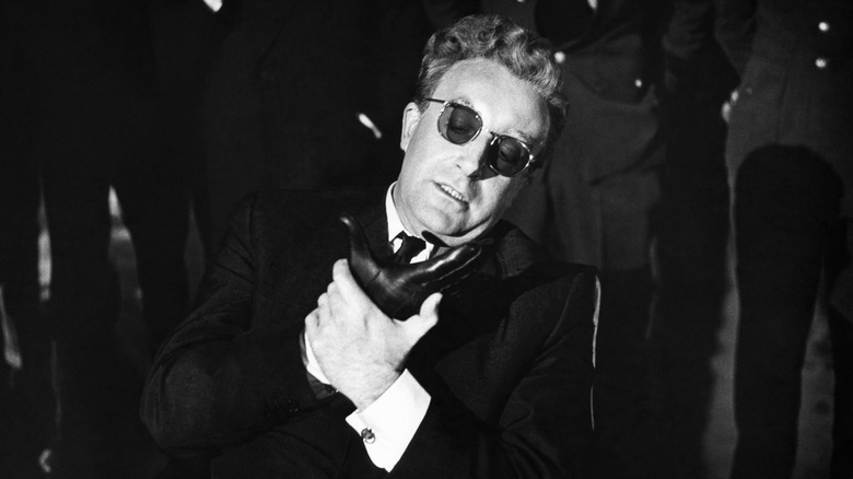 Dr. Strangelove holds his gloved hand in 'Dr. Strangelove' (1964)