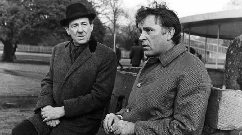 Alec Leamus talks to someone on a bench in 'The Spy Who Came in from the Cold' (1965)