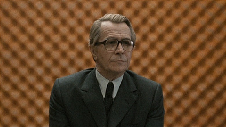 George Smiley sitting in front of patterned wall in 'Tinker Tailor Soldier Spy' (2011)