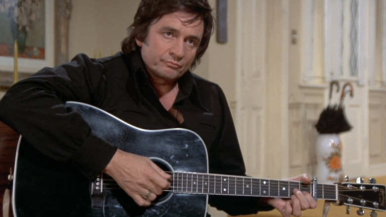 Tommy Brown plays his guitar in "Swan Song" (1974)