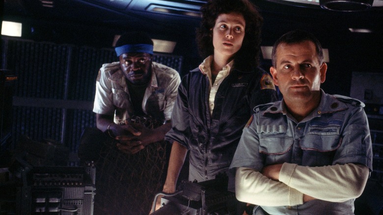 Ellen Ripley and crew inspecting suspicious noises in Alien (1979)